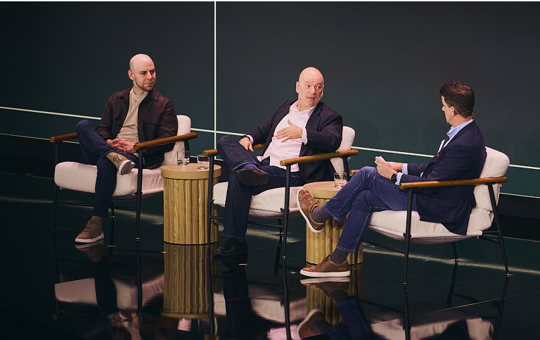 Adam Grant, Andrew McAfee and Alexi Robichaux talking on the stage at Uplift