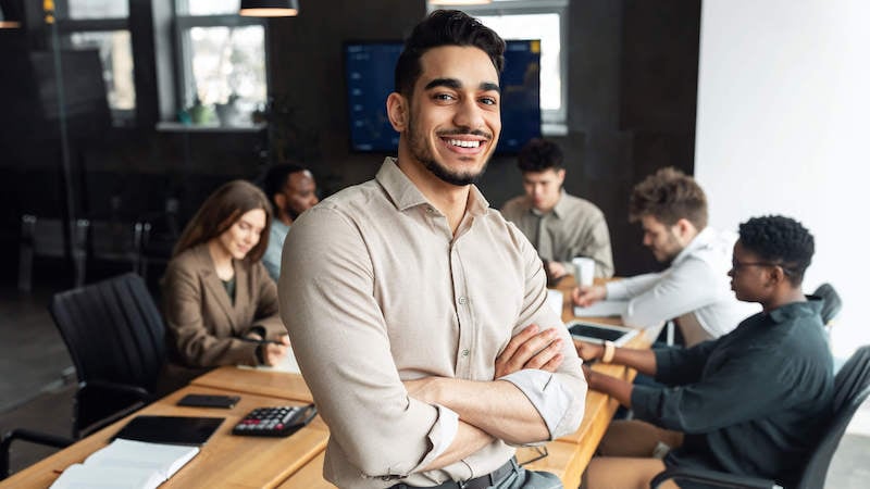 operating-model-man-smiling-standing-up-in-conference-room