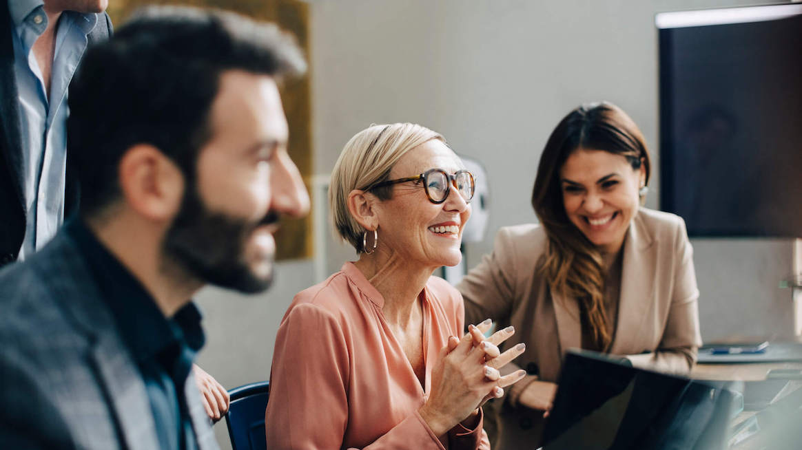 employee-engagement-strategies-team-smiling-during-meeting