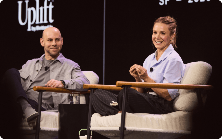 Adam Grant and Kristen Bell on stage at Uplift