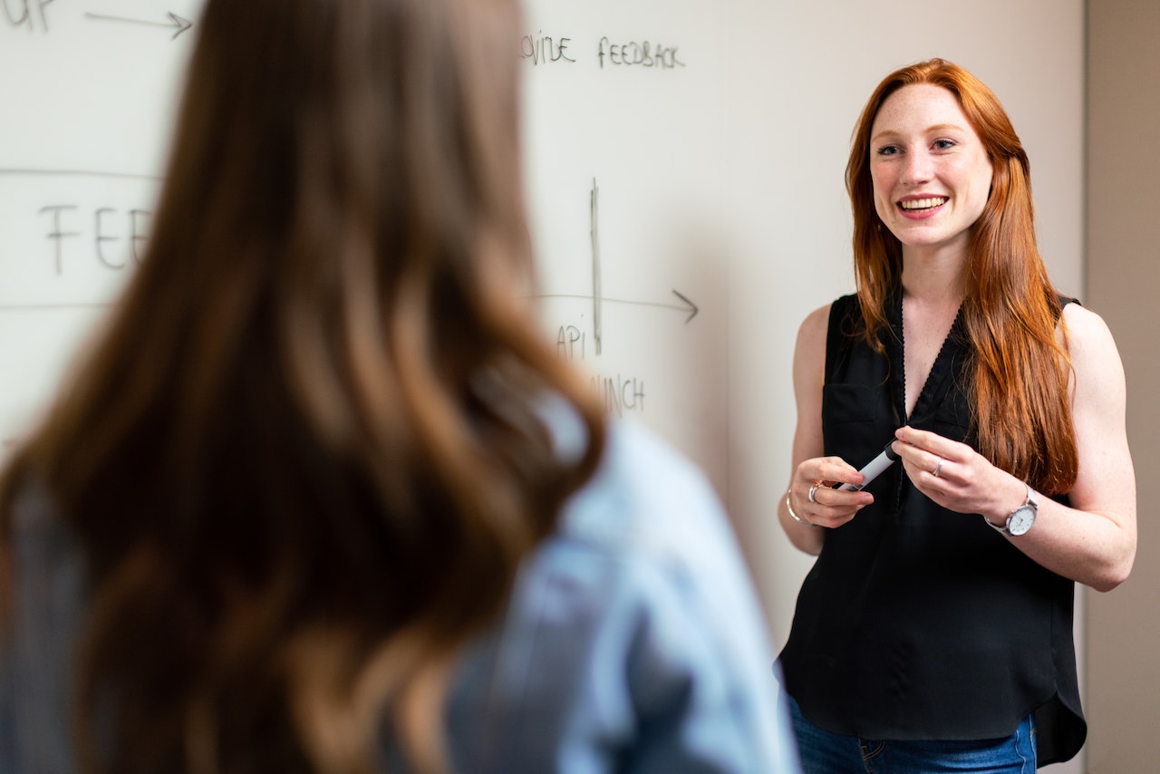 confident-woman-looking-at-coworker-while-giving-project-presentation-business-communication-skills