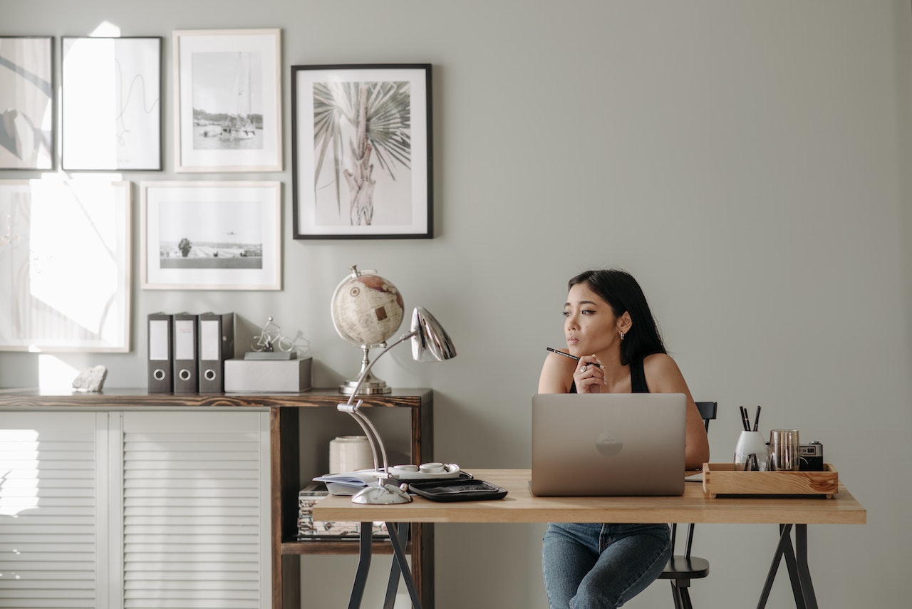 girl-sitting-in-her-home-office-thinking