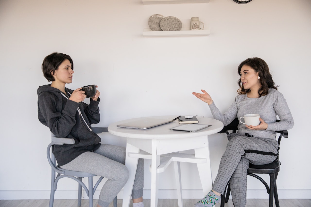 woman-with-her-coach-talking-while-drinking-coffee-communication-coach