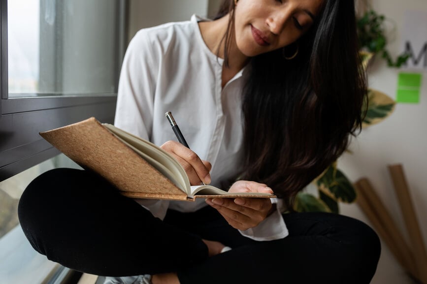 sad girl writing in diary