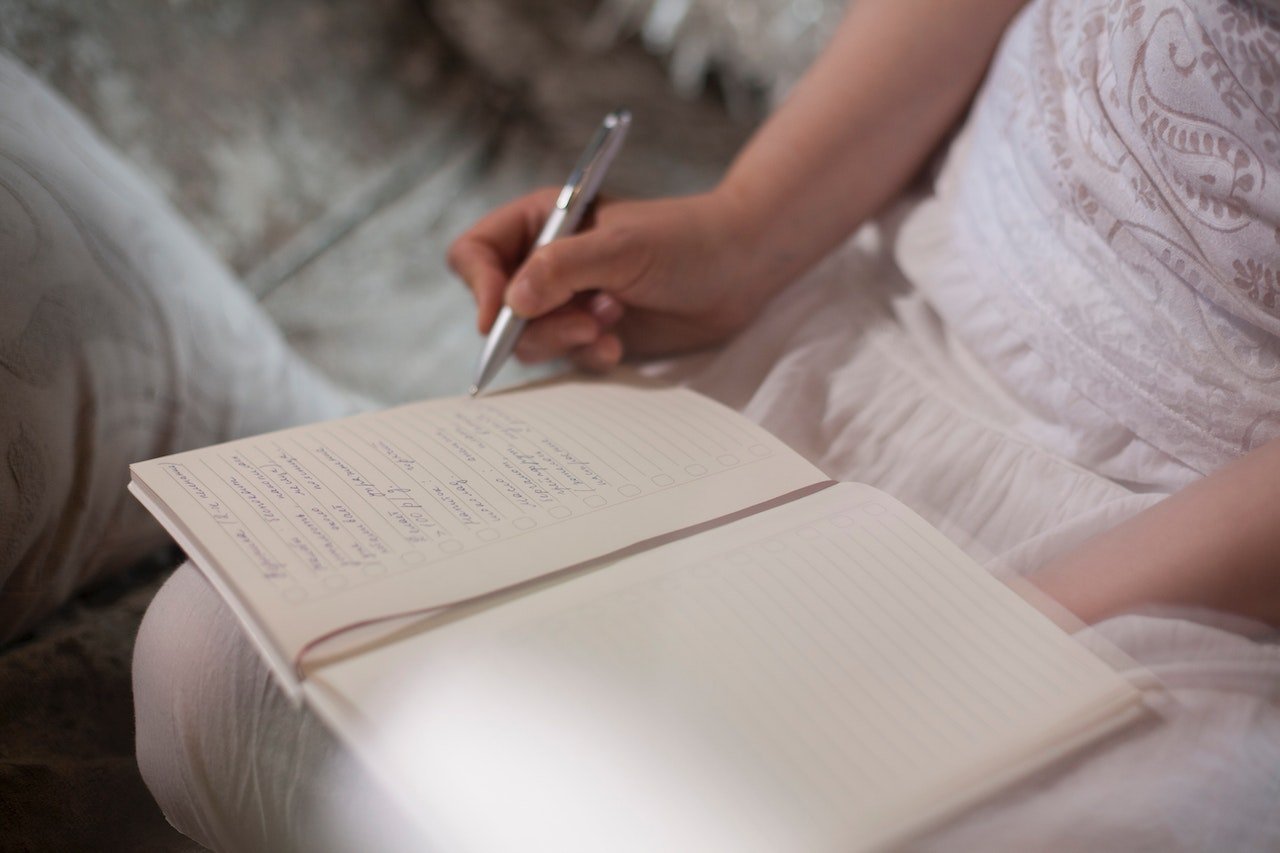 woman-writing-on-journal-daily-journal-prompts